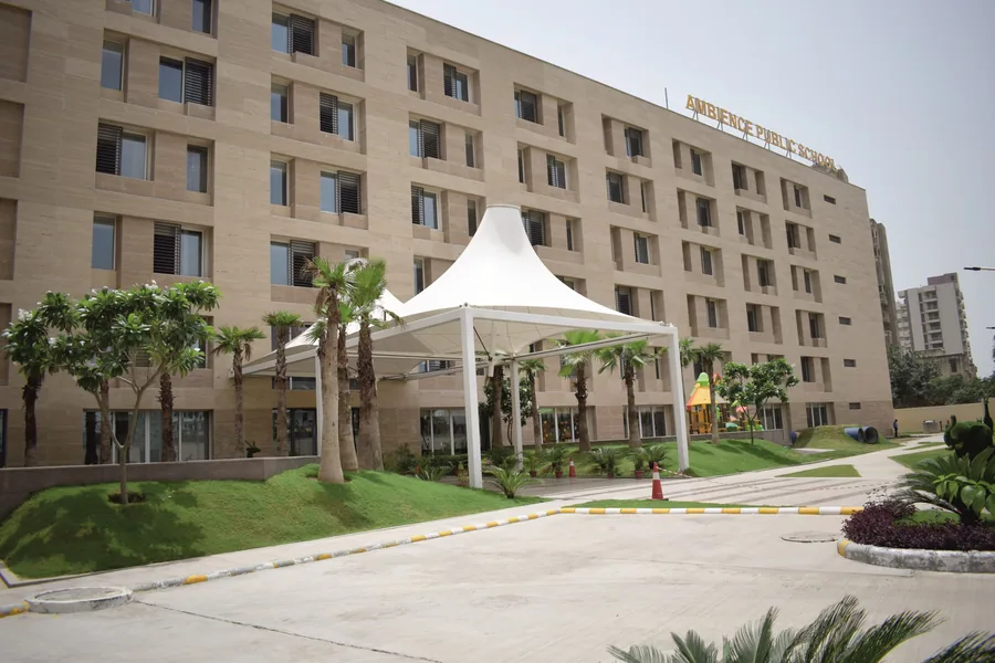 The academic building with its white tensile canopy, palm avenue and landscaped forecourt