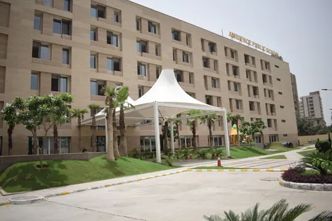 The academic building with its white tensile canopy, palm avenue and landscaped forecourt