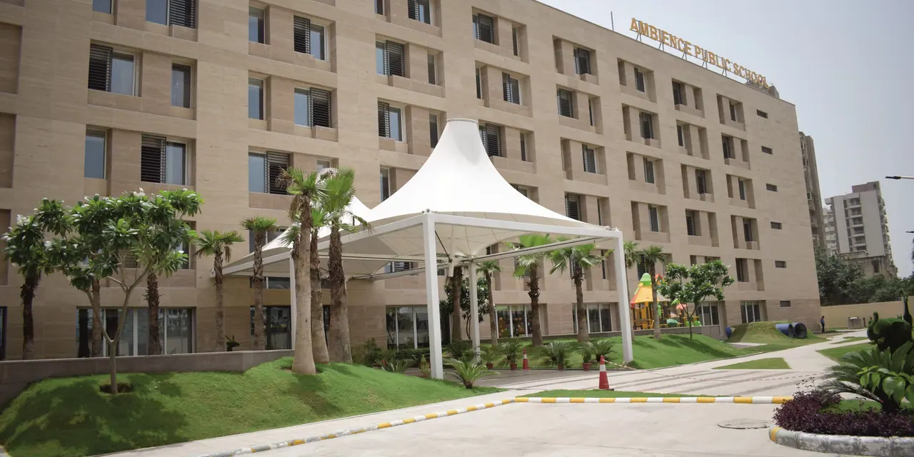 The academic building with its white tensile canopy, palm avenue and landscaped forecourt